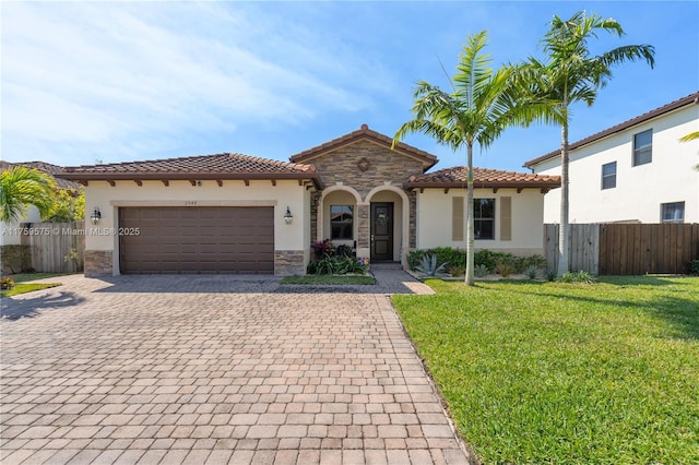 2548 SE 1st St, Homestead, FL 33033 - mediterranean / spanish home featuring stucco siding, a tile roof, decorative driveway, stone siding, and a front yard