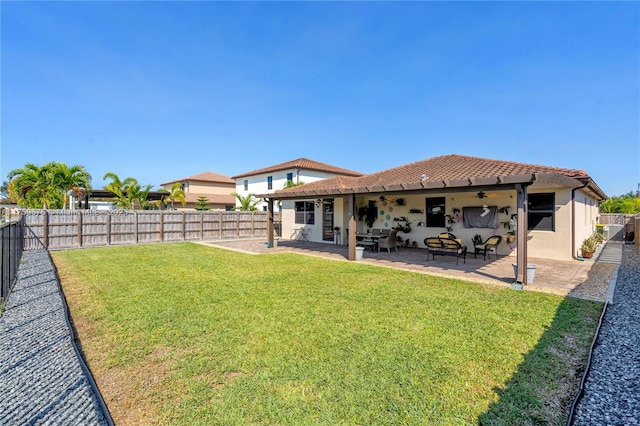 2548 SE 1st St, Homestead, FL 33033 - rear view of house featuring a tile roof, a fenced backyard, a lawn, ceiling fan, and a patio
