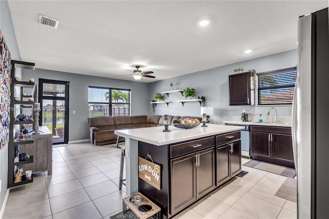 2548 SE 1st St, Homestead, FL 33033 - kitchen with visible vents, freestanding refrigerator, dark brown cabinetry, ceiling fan, and light countertops
