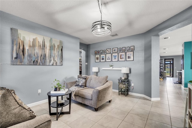 living area featuring light tile patterned floors, baseboards, and visible vents