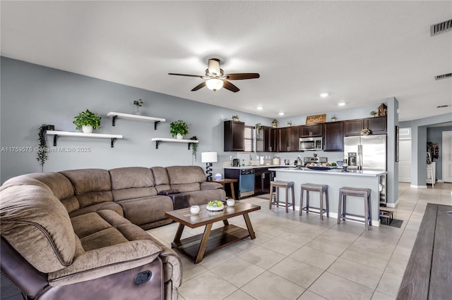 living area with light tile patterned floors, recessed lighting, visible vents, and ceiling fan