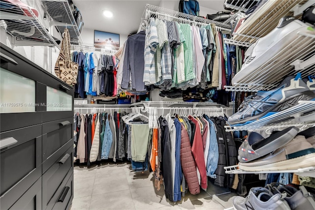 walk in closet with light tile patterned flooring