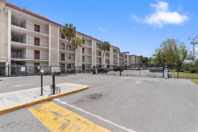 view of car parking with a gate and fence