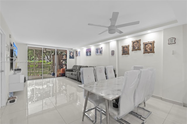 dining area featuring a wall of windows, light tile patterned floors, baseboards, and ceiling fan