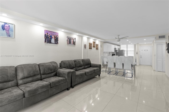 living room featuring light tile patterned floors, visible vents, recessed lighting, and a ceiling fan