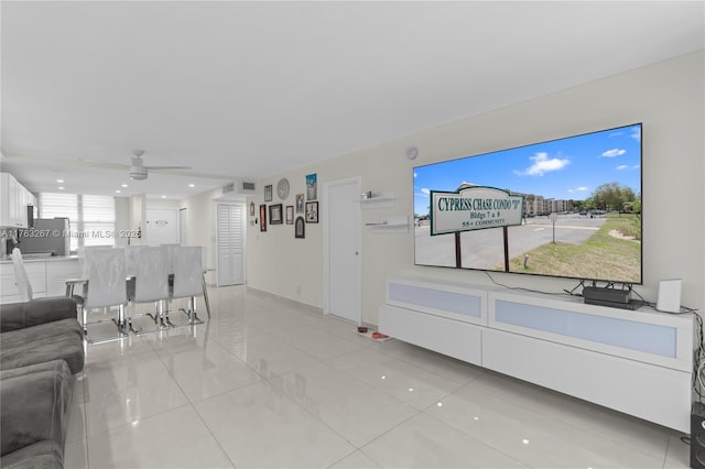 living room featuring light tile patterned floors and a ceiling fan