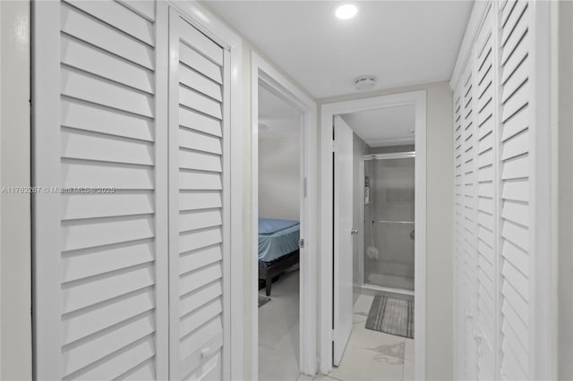 hallway with recessed lighting and marble finish floor