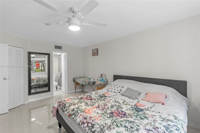 bedroom with tile patterned flooring, visible vents, baseboards, ensuite bathroom, and a ceiling fan