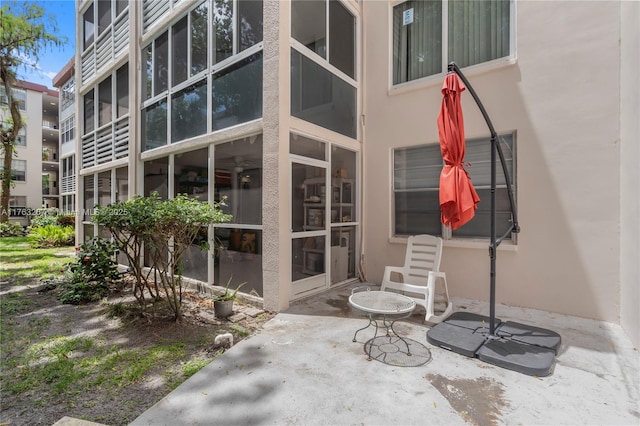 doorway to property featuring stucco siding and a patio