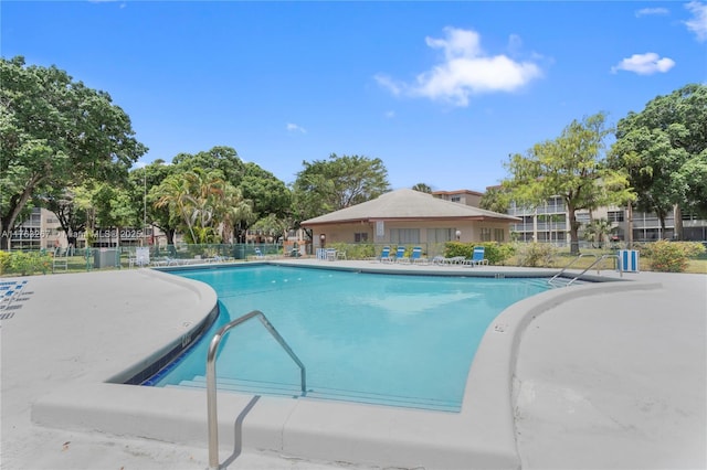 community pool featuring a patio and fence