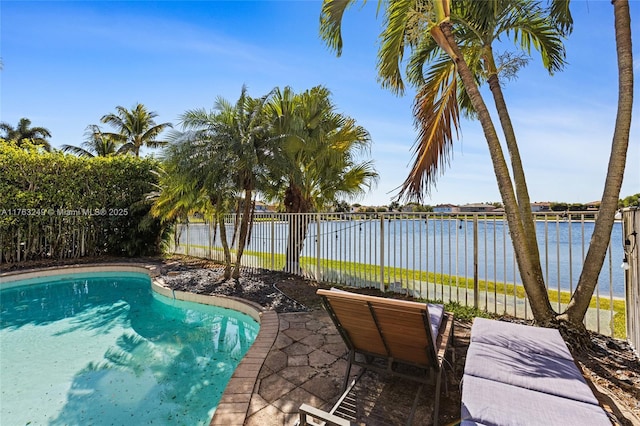 view of swimming pool with a fenced backyard and a water view