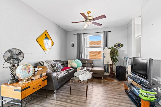 living room featuring wood finished floors and ceiling fan