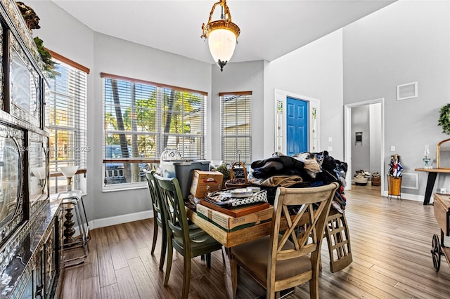 dining area with visible vents, baseboards, and hardwood / wood-style floors