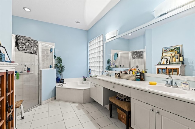 bathroom with a bath, a stall shower, double vanity, and a sink