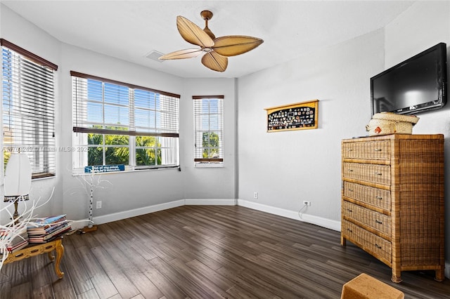 unfurnished bedroom with visible vents, wood finished floors, baseboards, and ceiling fan