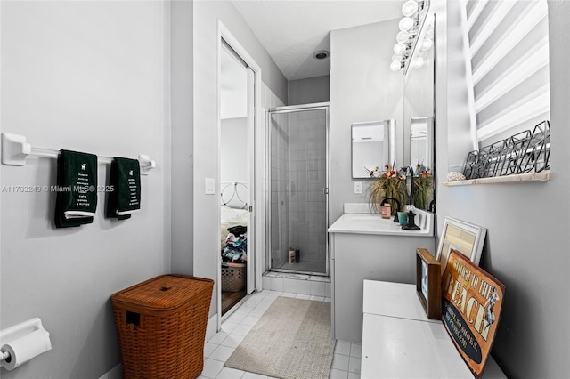 bathroom featuring tile patterned floors, vanity, and a shower stall