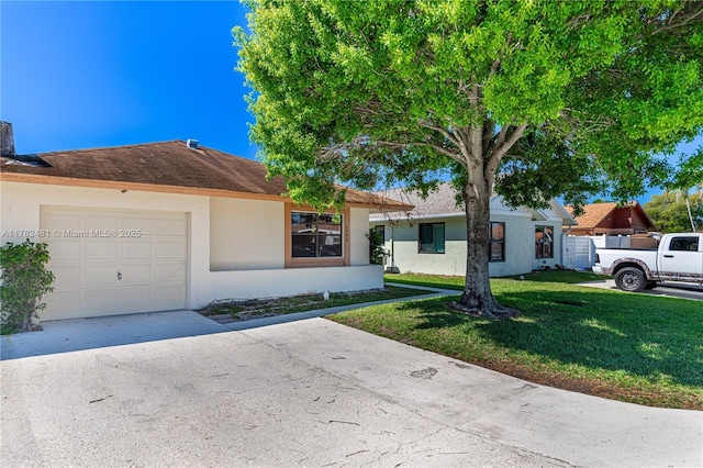 single story home featuring a garage, stucco siding, driveway, and a front lawn