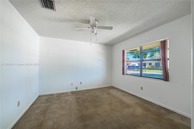 carpeted empty room with visible vents, baseboards, a textured ceiling, and a ceiling fan