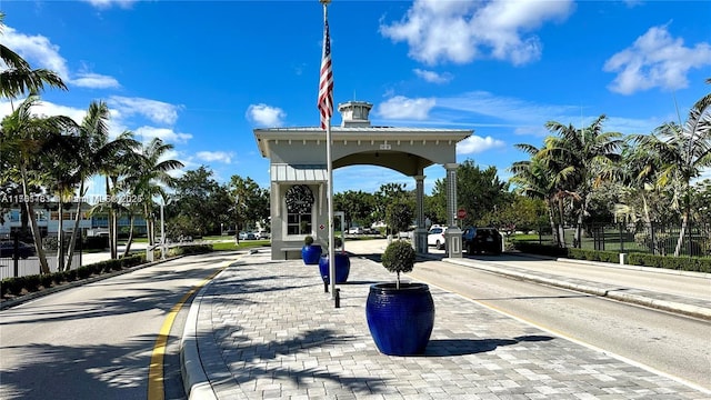 view of street featuring street lights, traffic signs, curbs, and sidewalks