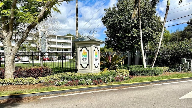 community sign with fence