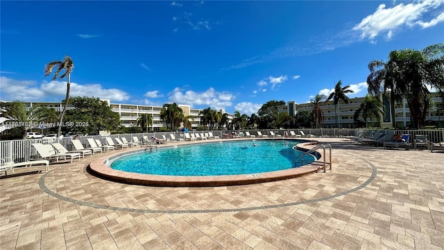 community pool featuring a patio and fence