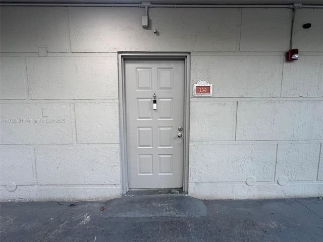 view of exterior entry with concrete block siding