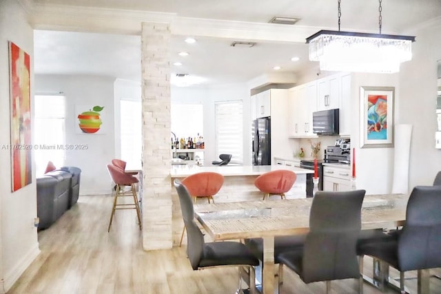 dining area featuring recessed lighting, light wood-style flooring, visible vents, and decorative columns