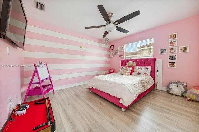 bedroom featuring visible vents, baseboards, and wood finished floors