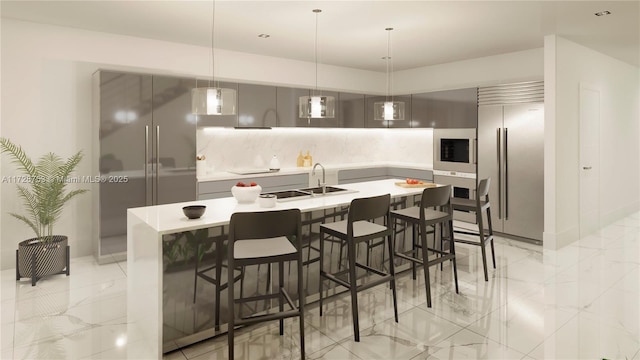 kitchen with tasteful backsplash, marble finish floor, built in fridge, and a sink