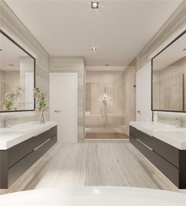 bathroom featuring a walk in shower, two vanities, and a sink