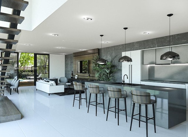 kitchen with decorative light fixtures, dark countertops, a breakfast bar area, and floor to ceiling windows