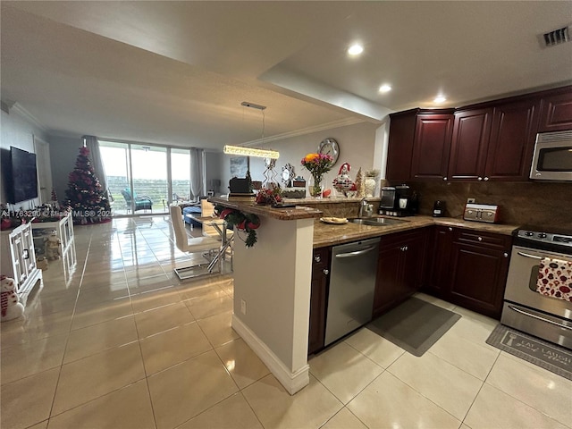 kitchen featuring visible vents, light tile patterned flooring, a sink, appliances with stainless steel finishes, and crown molding