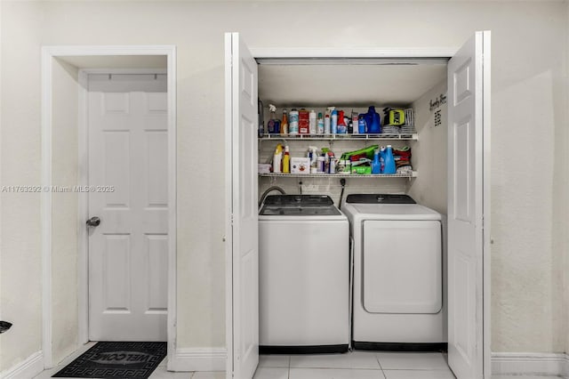 laundry area with light tile patterned floors, laundry area, and independent washer and dryer