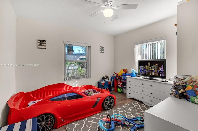 bedroom with a ceiling fan and wood finished floors