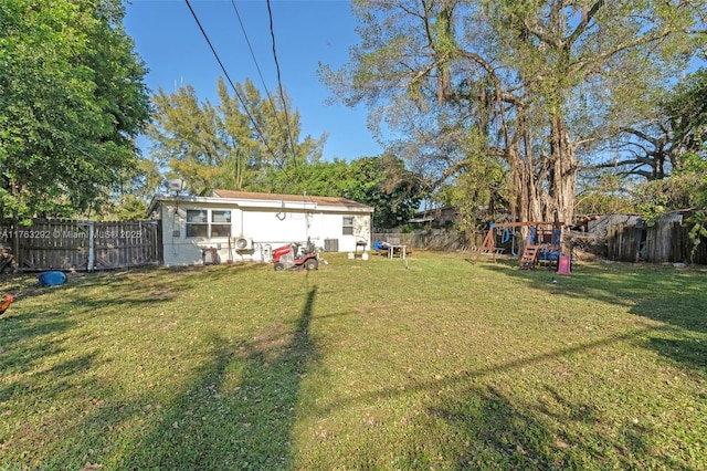 view of yard with a playground and a fenced backyard