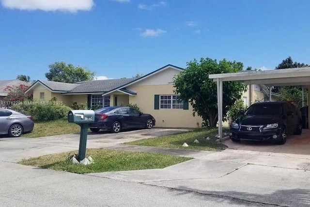 view of front of property with stucco siding and driveway