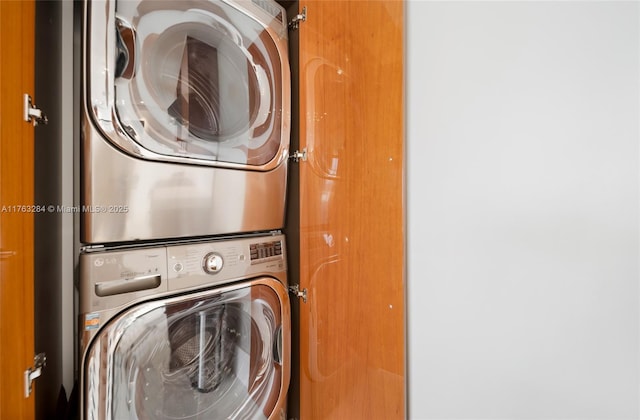 laundry room featuring laundry area and stacked washer / drying machine