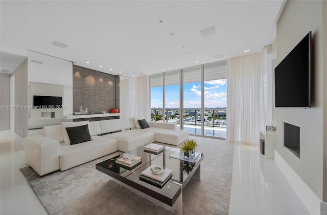 living room featuring visible vents, recessed lighting, and a wall of windows