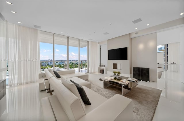 living room with recessed lighting, visible vents, and floor to ceiling windows