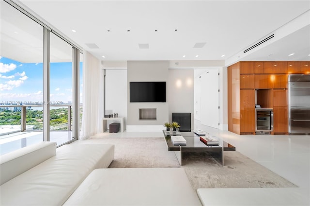 living area featuring a wall of windows and visible vents