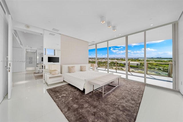 bedroom with access to outside and expansive windows