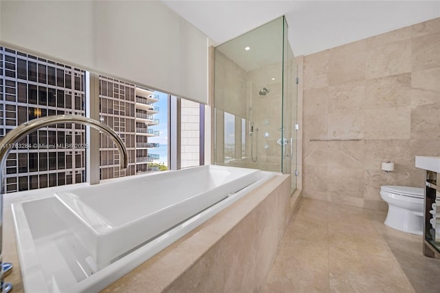 bathroom featuring a bath, a stall shower, tile walls, toilet, and tile patterned floors