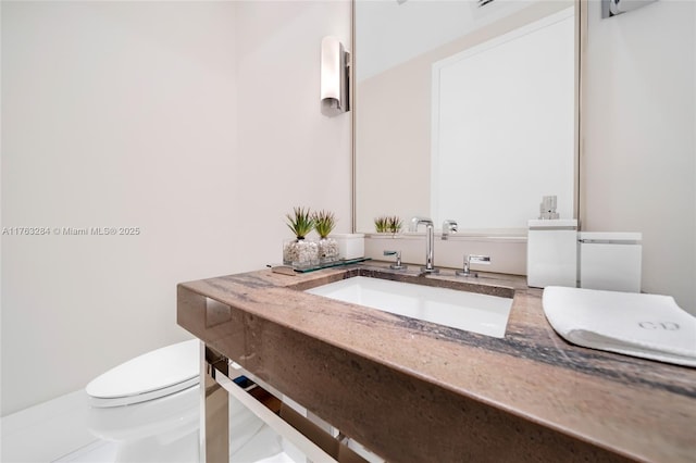 bathroom featuring toilet and vanity