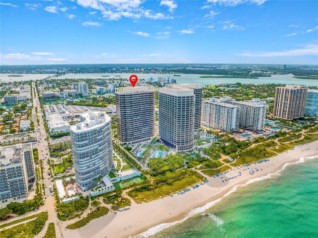 aerial view with a water view, a city view, and a view of the beach