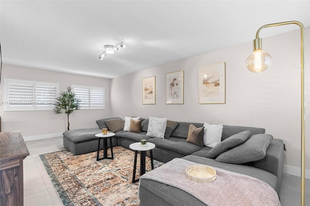 living room featuring light tile patterned flooring and baseboards