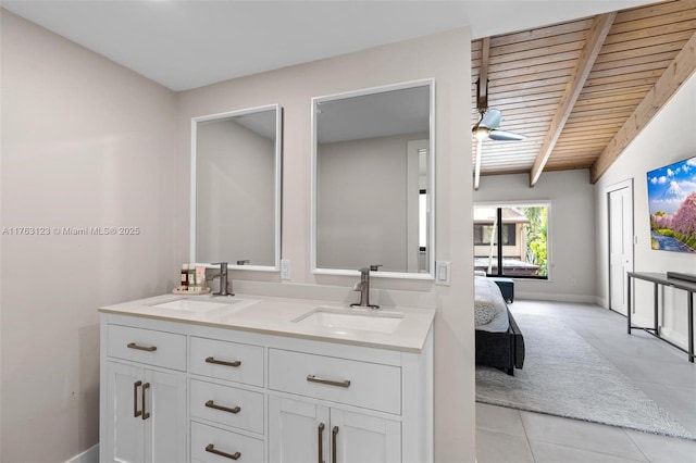 bathroom with beam ceiling, tile patterned flooring, a ceiling fan, and a sink