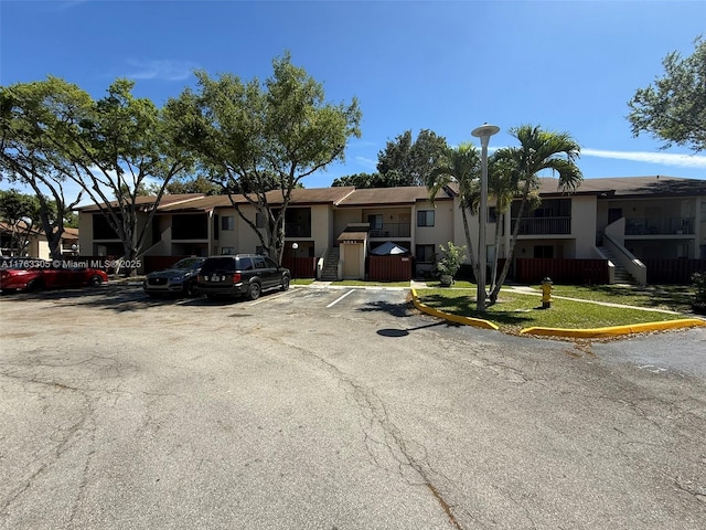 single story home with a residential view, stucco siding, and uncovered parking