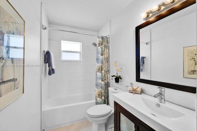 full bath with vanity, toilet, shower / tub combo, and a textured ceiling