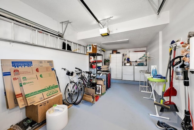 garage featuring a garage door opener and separate washer and dryer