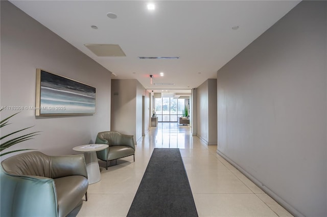 20379 W Country Club Dr Unit 1938, Aventura, FL 33180 - corridor with a wall of windows and light tile patterned flooring
